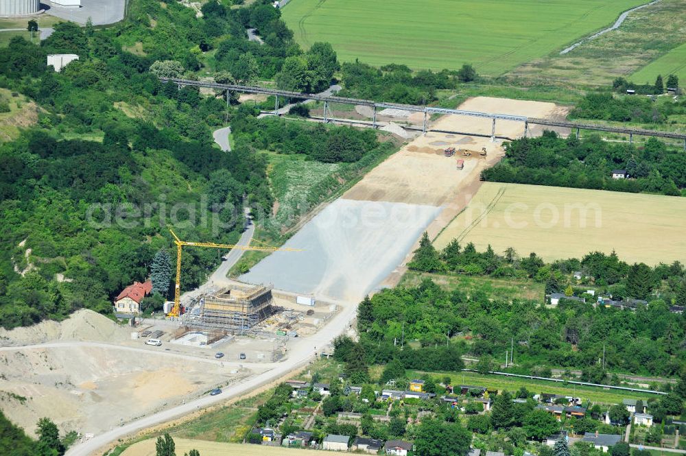 Bernburg from the bird's eye view: Baustelle vom Neubau der Ortsumgehung Bernburg Bundesstraße B 6n mit Anschlußstelle an die Autobahn / Bundesautobahn A 14 in Sachsen-Anhalt. Ein Projekt von EUROVIA. Construction site of the new circuitous road B6n Bernburg with the new junction on to the freeway in the near of Bernburg in Saxony-Anhalt.