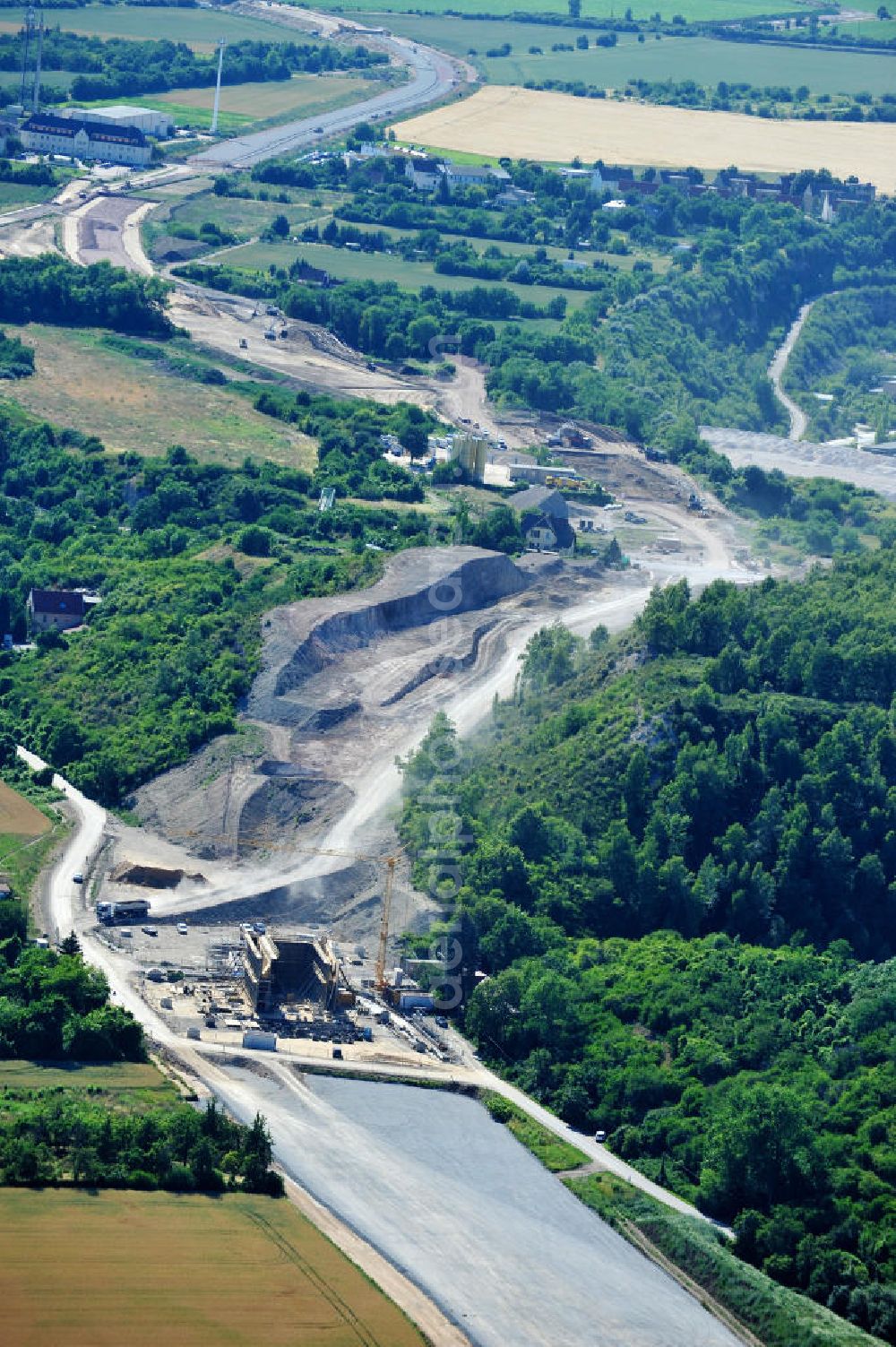 Bernburg from the bird's eye view: Baustelle vom Neubau der Ortsumgehung Bernburg Bundesstraße B 6n mit Anschlußstelle an die Autobahn / Bundesautobahn A 14 in Sachsen-Anhalt. Ein Projekt von EUROVIA. Construction site of the new circuitous road B6n Bernburg with the new junction on to the freeway in the near of Bernburg in Saxony-Anhalt.