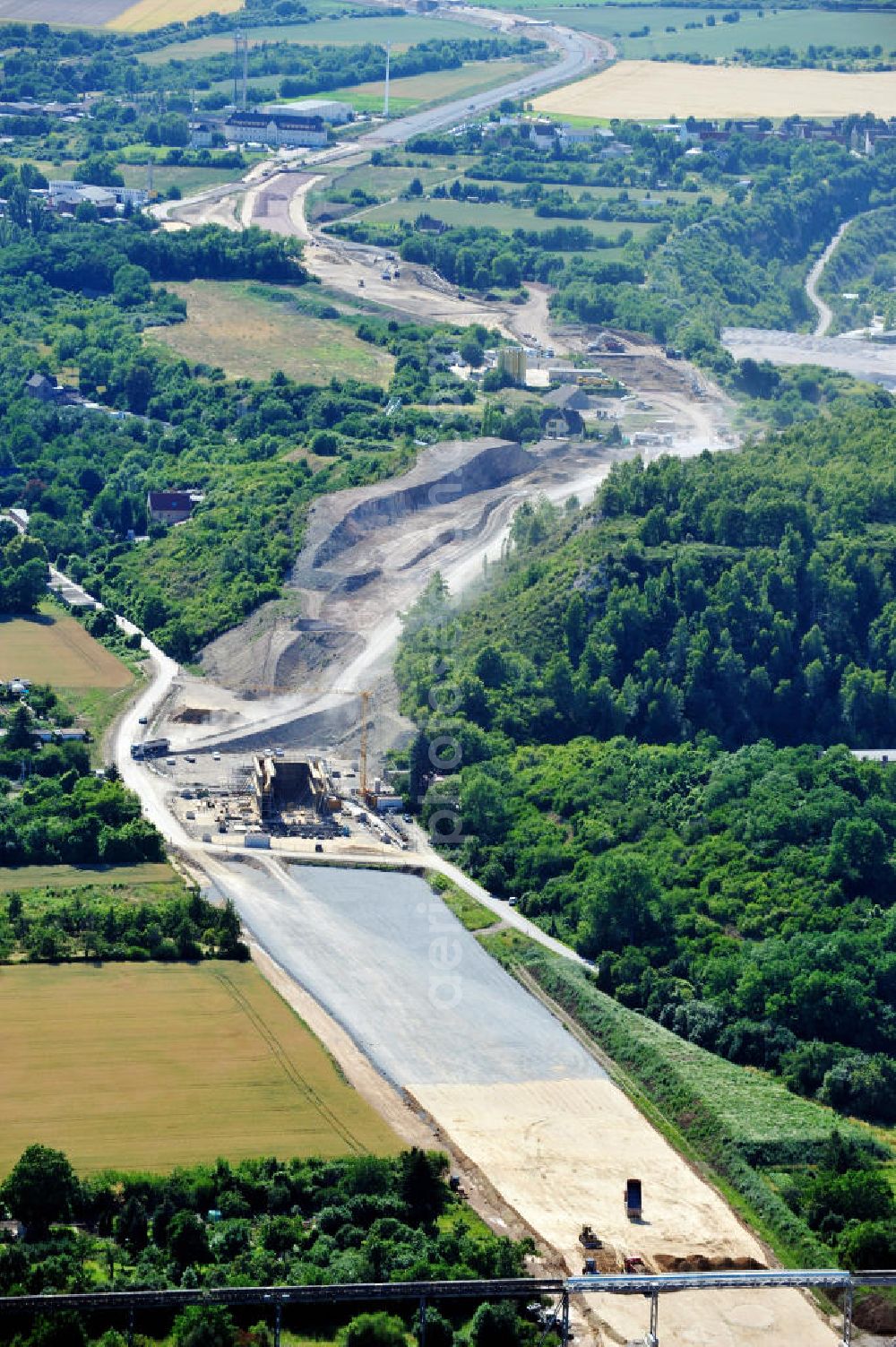 Aerial image Bernburg - Baustelle vom Neubau der Ortsumgehung Bernburg Bundesstraße B 6n mit Anschlußstelle an die Autobahn / Bundesautobahn A 14 in Sachsen-Anhalt. Ein Projekt von EUROVIA. Construction site of the new circuitous road B6n Bernburg with the new junction on to the freeway in the near of Bernburg in Saxony-Anhalt.