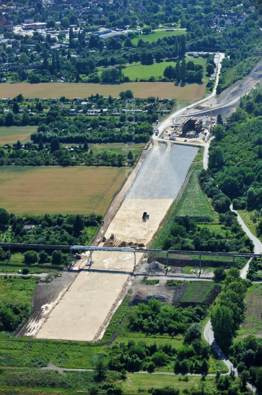 Aerial photograph Bernburg - Baustelle vom Neubau der Ortsumgehung Bernburg Bundesstraße B 6n mit Anschlußstelle an die Autobahn / Bundesautobahn A 14 in Sachsen-Anhalt. Ein Projekt von EUROVIA. Construction site of the new circuitous road B6n Bernburg with the new junction on to the freeway in the near of Bernburg in Saxony-Anhalt.