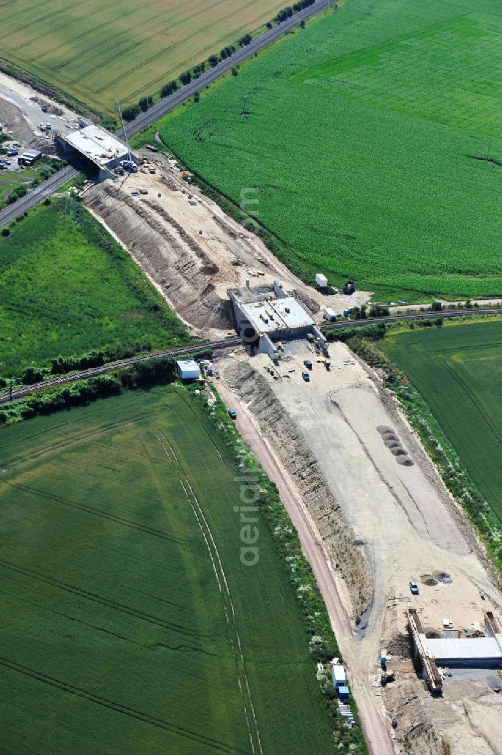 Bernburg from the bird's eye view: Baustelle vom Neubau der Ortsumgehung Bernburg Bundesstraße B 6n mit Anschlußstelle an die Autobahn / Bundesautobahn A 14 in Sachsen-Anhalt. Ein Projekt von EUROVIA. Construction site of the new circuitous road B6n Bernburg with the new junction on to the freeway in the near of Bernburg in Saxony-Anhalt.