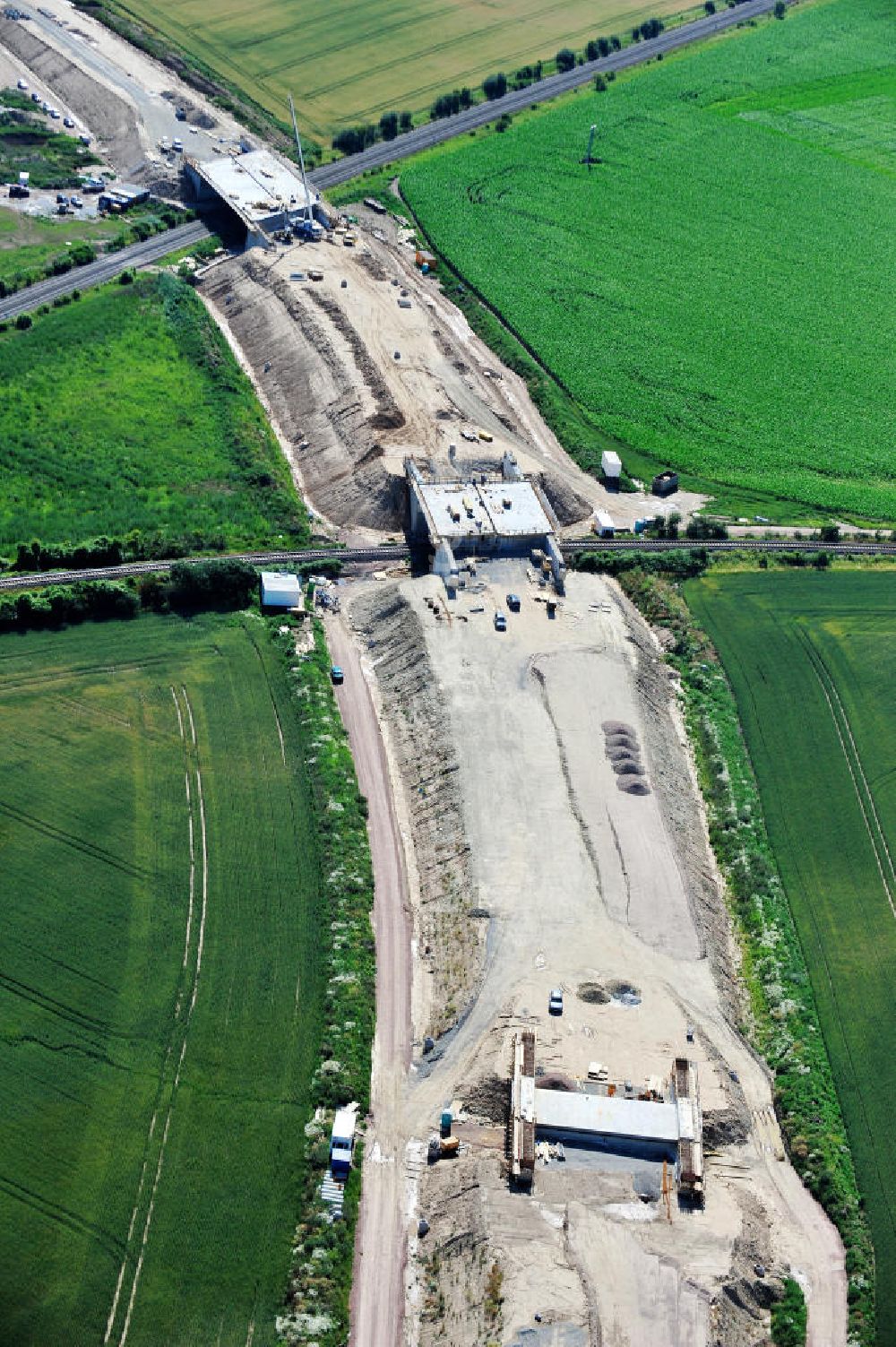 Aerial image Bernburg - Baustelle vom Neubau der Ortsumgehung Bernburg Bundesstraße B 6n mit Anschlußstelle an die Autobahn / Bundesautobahn A 14 in Sachsen-Anhalt. Ein Projekt von EUROVIA. Construction site of the new circuitous road B6n Bernburg with the new junction on to the freeway in the near of Bernburg in Saxony-Anhalt.