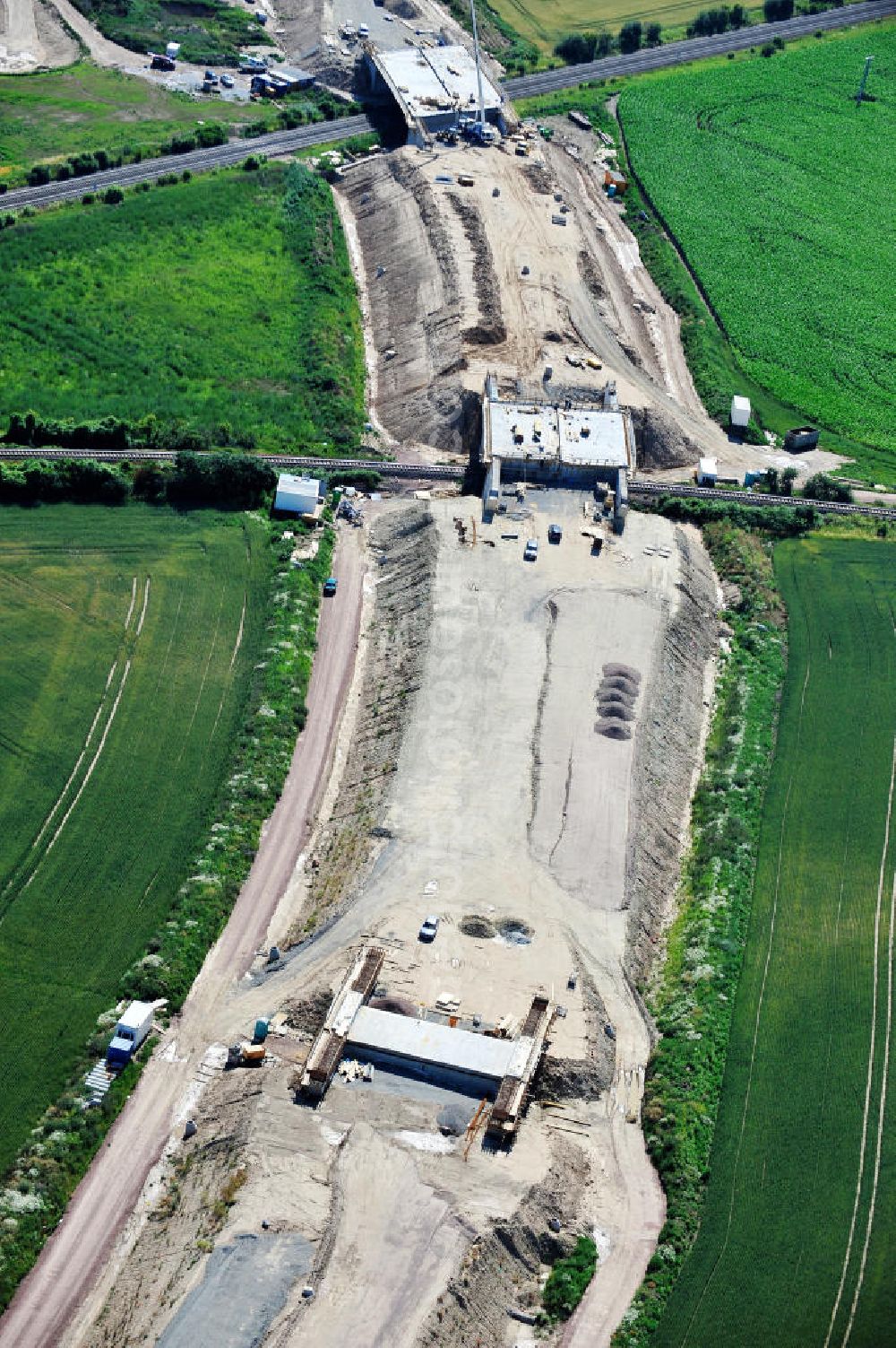 Aerial photograph Bernburg - Baustelle vom Neubau der Ortsumgehung Bernburg Bundesstraße B 6n mit Anschlußstelle an die Autobahn / Bundesautobahn A 14 in Sachsen-Anhalt. Ein Projekt von EUROVIA. Construction site of the new circuitous road B6n Bernburg with the new junction on to the freeway in the near of Bernburg in Saxony-Anhalt.