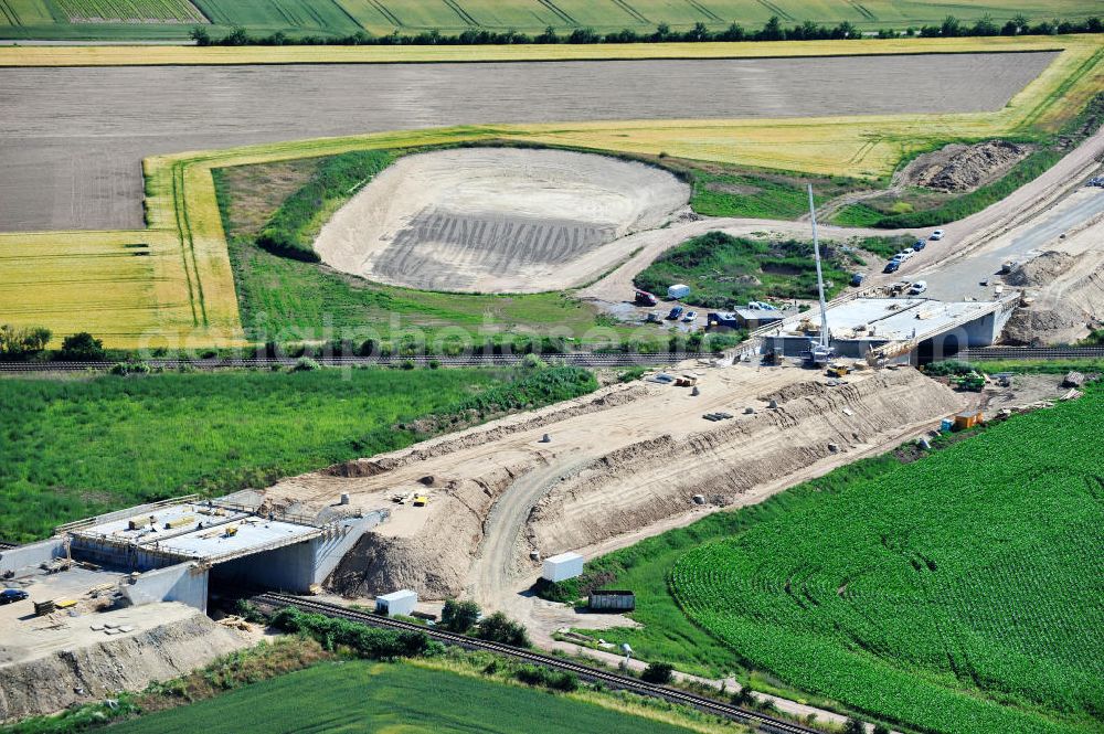 Bernburg from the bird's eye view: Baustelle vom Neubau der Ortsumgehung Bernburg Bundesstraße B 6n mit Anschlußstelle an die Autobahn / Bundesautobahn A 14 in Sachsen-Anhalt. Ein Projekt von EUROVIA. Construction site of the new circuitous road B6n Bernburg with the new junction on to the freeway in the near of Bernburg in Saxony-Anhalt.