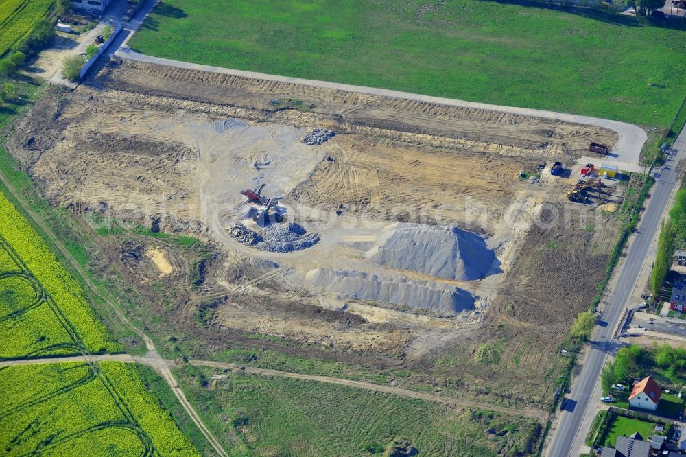 Berlin from above - Construction site on Pilgramer Strasse in the Mahlsdorf part of the district of Marzahn-Hellersdorf in Berlin in Germany. The site is located opposite single family homes and is surrounded by fields and meadows. It is supposed to become a furniture store