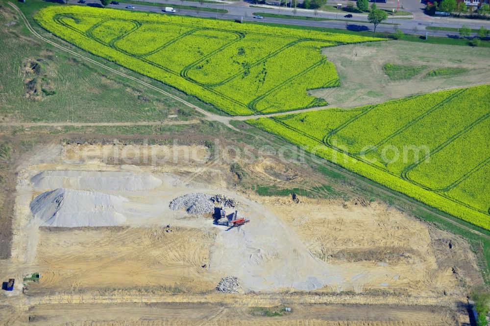 Berlin from the bird's eye view: Construction site on Pilgramer Strasse in the Mahlsdorf part of the district of Marzahn-Hellersdorf in Berlin in Germany. The site is located opposite single family homes and is surrounded by fields and meadows. It is supposed to become a furniture store