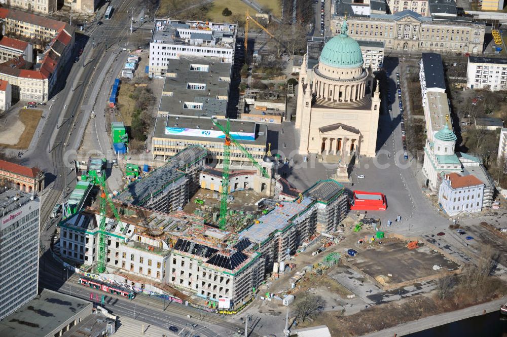 Potsdam from the bird's eye view: Construction site of the Potsdam Stadtschloss at the Old Market. In the background is the University of Applied Sciences Potsdam and St. Nikolai Church. Building contractors company: BAM Deutschland AG