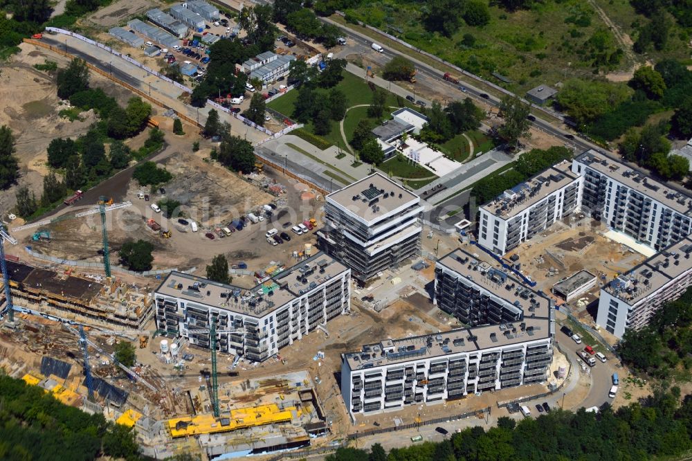 Aerial photograph Warschau - Construction site of the settlement Zoliborz Artystyczny in the Zoliborz District of Warsaw in Poland. The complex is located adjacent to the Powazki cemetery in the South of the district. The estate will be created including artistic elements such as murals. It is developed by Dom Development whose offices are located in the building in the green space with the oval path