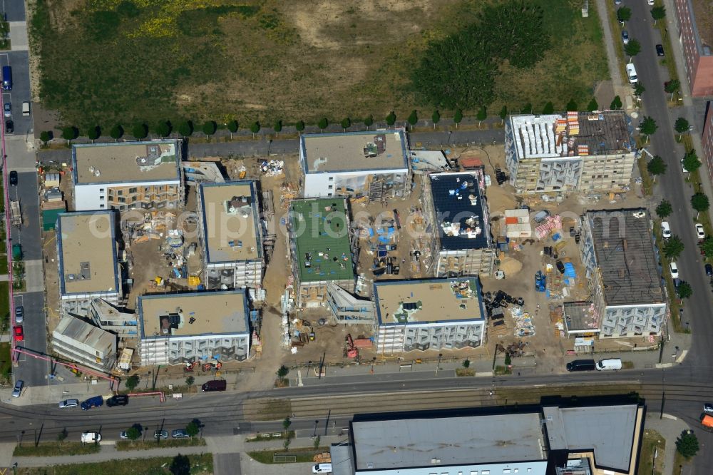 Aerial photograph Berlin-Adlershof - Zueblin AG is currently building on behalf of the Students Schlachtensee eG in Science Campus Adlershof at the Karl-Ziegler-Strasse student village. The 380 residential units for students in 10 houses will be completed in summer 2014. The special feature of the student village are the common areas like the living room and kitchen, which group the individual floors of the residential landscape