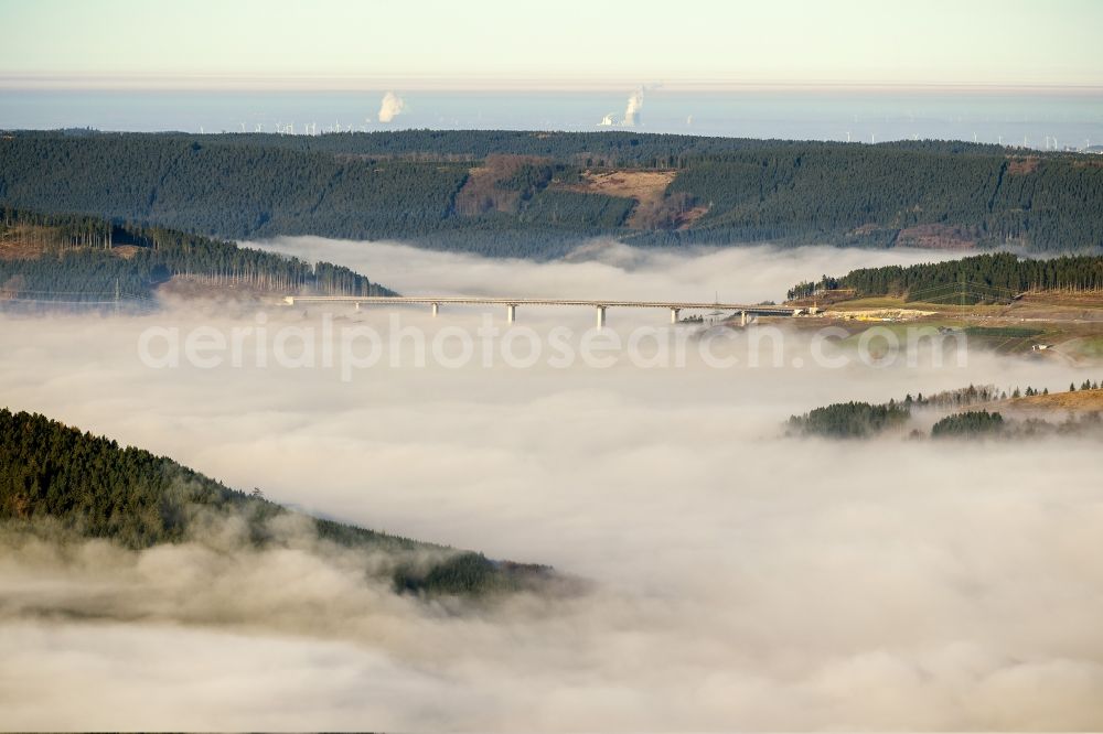 Aerial photograph Rüthen - From a fog and cloud layer surrounded construction of the Talbruecke Nuttlar at Ruethen at the BAB motorway A46 in the Sauerland region in North Rhine-Westphalia. After completion, it will be the highest conversion of NRW