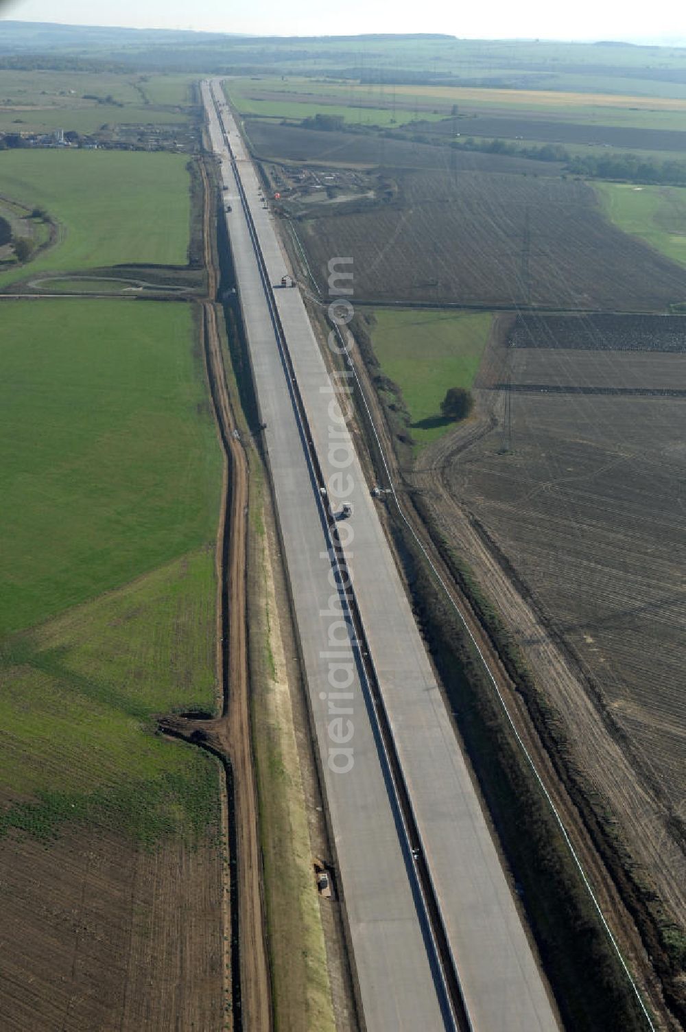 Wenigenlupnitz from the bird's eye view: Blick auf die Baustelle des Autobahnverlauf in Richtung Osten zu einer Unterführung mit Regenrückhaltebecken und der südlichen (v) und nördlichen (h) PWC-Anlage / Parkplatz mit WC / Rastplatz der A4 bei Wenigenlupnitz. Der Neubau ist Teil des Projekt Nordverlegung / Umfahrung Hörselberge der Autobahn E40 / A4 in Thüringen bei Eisenach. Durchgeführt werden die im Zuge dieses Projektes notwendigen Arbeiten unter an derem von den Mitarbeitern der Niederlassung Weimar der EUROVIA Verkehrsbau Union sowie der Niederlassungen Abbruch und Erdbau, Betonstraßenbau, Ingenieurbau und TECO Schallschutz der EUROVIA Beton sowie der DEGES.