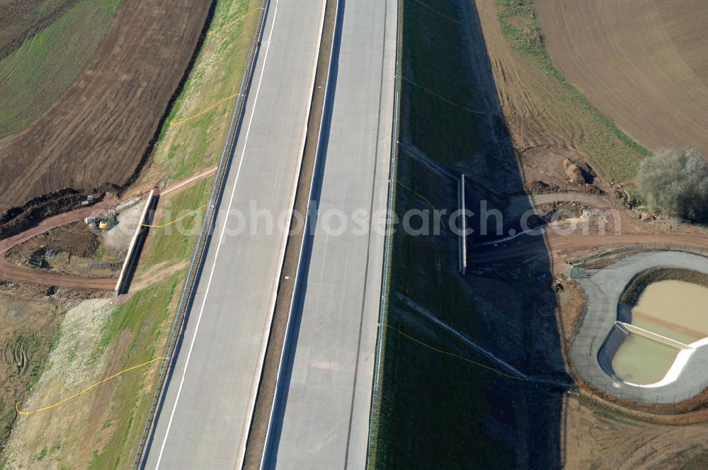 Madelungen from the bird's eye view: Blick auf die Baustelle einer Unterführung der A4 mit Regenrückhaltebecken bei Madelungen. Der Neubau ist Teil des Projekt Nordverlegung / Umfahrung Hörselberge der Autobahn E40 / A4 in Thüringen bei Eisenach. Der Neubau ist Teil des Projekt Nordverlegung / Umfahrung Hörselberge der Autobahn E40 / A4 in Thüringen bei Eisenach. Durchgeführt werden die im Zuge dieses Projektes notwendigen Arbeiten unter an derem von den Mitarbeitern der Niederlassung Weimar der EUROVIA Verkehrsbau Union sowie der Niederlassungen Abbruch und Erdbau, Betonstraßenbau, Ingenieurbau und TECO Schallschutz der EUROVIA Beton sowie der DEGES.