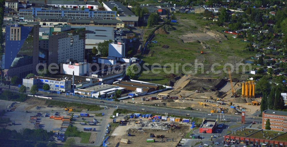 Berlin from the bird's eye view: On the Sonnenallee in the borough of Neukoelln in Berlin start the construction preparations for the extension of the motorway A100. In this phase of construction junction Sonnenallee will be built. In order to achieve freedom to build sales and industrial facilities were built back here. Located next to the construction site is the largest hotel in Berlin - the Estrel Berlin