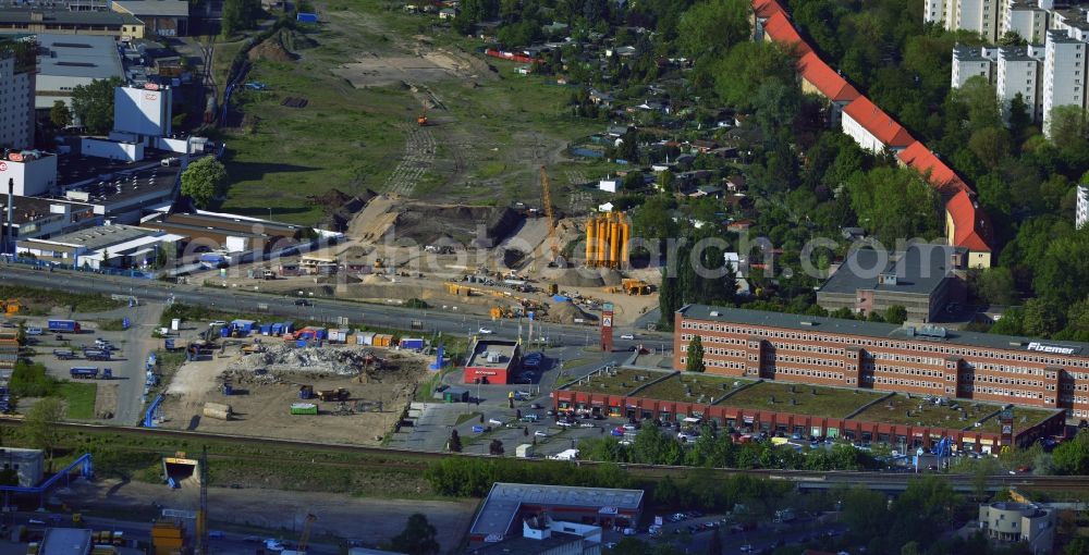 Aerial image Berlin - On the Sonnenallee in the borough of Neukoelln in Berlin start the construction preparations for the extension of the motorway A100. In this phase of construction junction Sonnenallee will be built. In order to achieve freedom to build sales and industrial facilities were built back here. In this area of ??the site, the highway is built as a trough structure