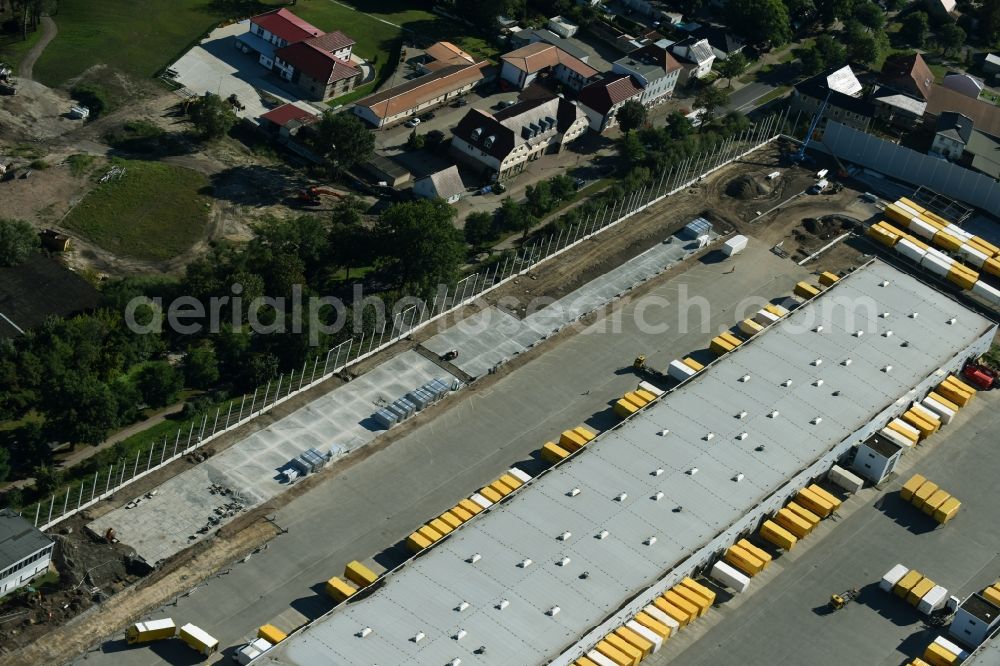 Rüdersdorf from the bird's eye view: Construction site for upgrading the Buildings of the DHL logistics hub and distribution center of the Deutsche Post Ruedersdorf in Brandenburg