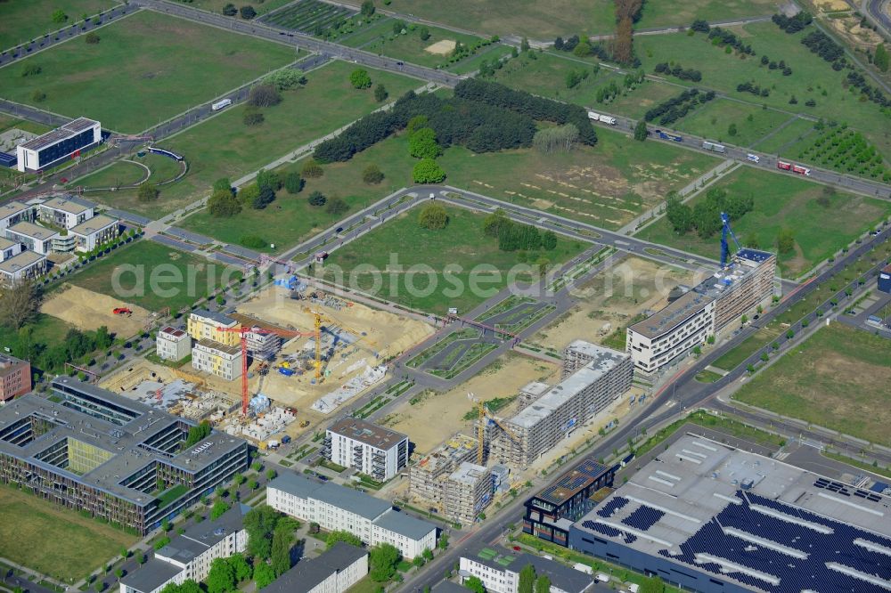 Berlin from above - Construction site of the residential area Isaac Newton Park in the technology park of Adlershof in the Treptow-Koepenick district of Berlin in Germany. Adlershof consists of the technology park and industrial area and wide green areas and residential estates. Elaborate architecture is characteristic for the economy location and is currently created on Newtonstrasse. Single family, multi-family and semi-detached houses are being built on site