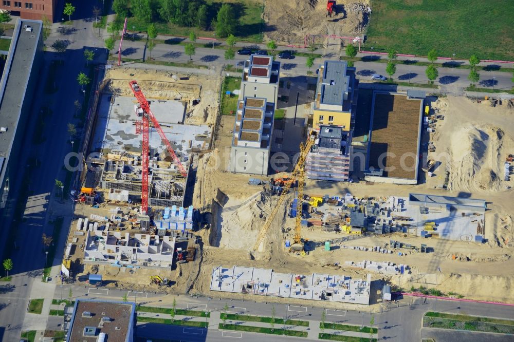 Aerial image Berlin - Construction site of the residential area Isaac Newton Park in the technology park of Adlershof in the Treptow-Koepenick district of Berlin in Germany. Adlershof consists of the technology park and industrial area and wide green areas and residential estates. Elaborate architecture is characteristic for the economy location and is currently created on Newtonstrasse. Single family, multi-family and semi-detached houses are being built on site