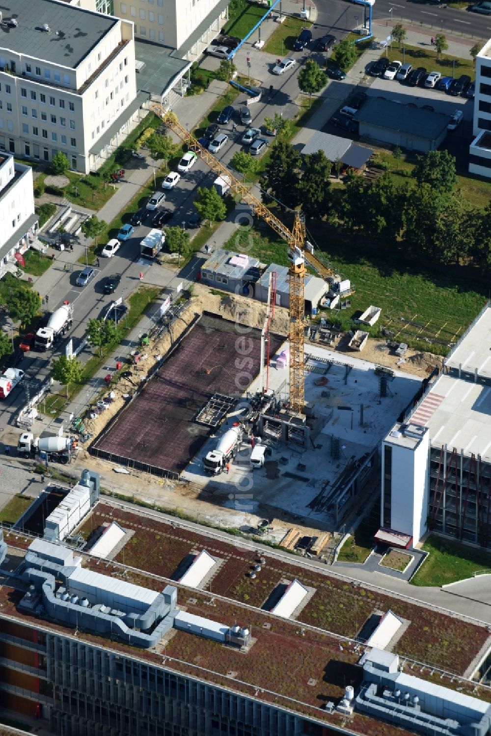 Berlin from the bird's eye view: Construction site to build a new office and commercial building EUROPA-CENTER Berlin Ecowiss through the Adolf Lupp GmbH + Co KG on Albert-Einstein-Strasse in the district Treptow-Koepenick in Berlin, Germany