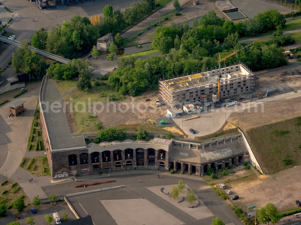 Aerial photograph Bochum - Construction site to build a new office and commercial building Kultur Ruhr GmbH in the West Park in Bochum at Ruhrgebiet in the state North Rhine-Westphalia. Nearby the ruin of the former entrance of the Krupp grounds