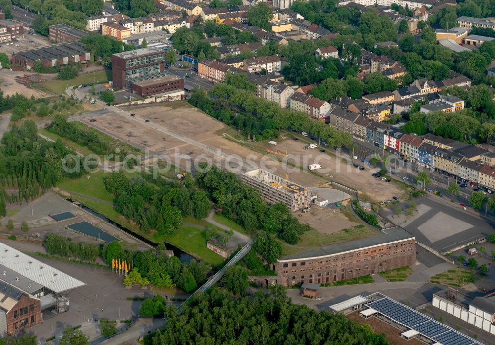 Aerial photograph Bochum - Construction site to build a new office and commercial building Kultur Ruhr GmbH in the West Park in Bochum at Ruhrgebiet in the state North Rhine-Westphalia. Nearby the ruin of the former entrance of the Krupp grounds