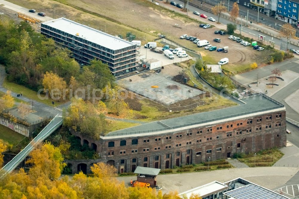 Bochum from the bird's eye view: Construction site to build a new office and commercial building Kultur Ruhr GmbH in the West Park in Bochum in the state North Rhine-Westphalia. Nearby the ruin of the former entrance of the Krupp grounds