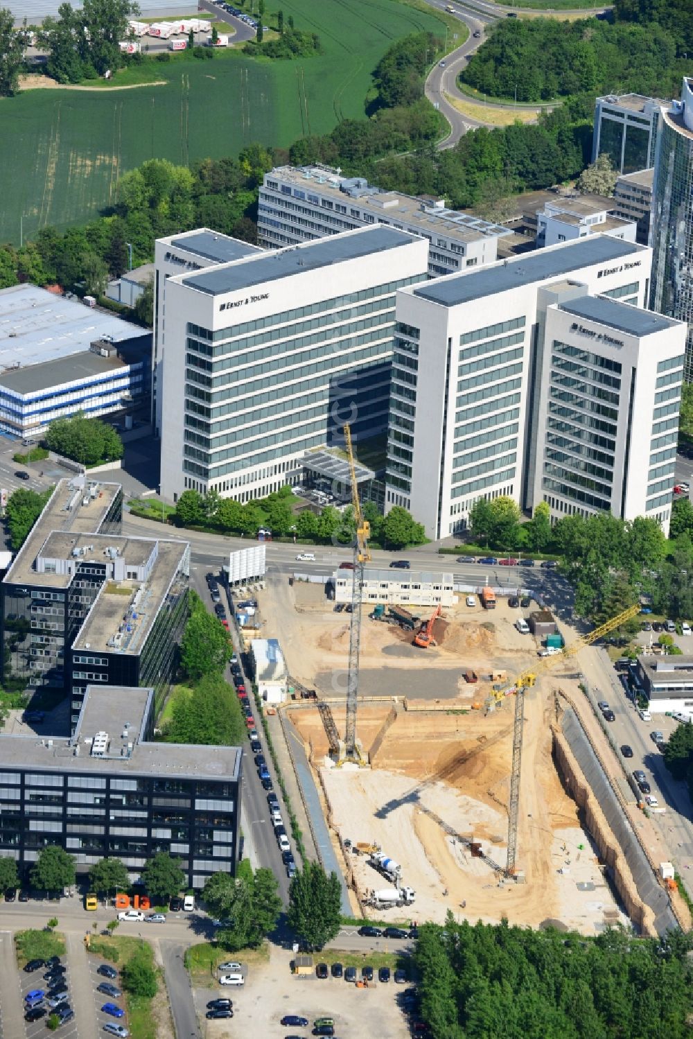 Eschborn from above - Construction site for new office and retail building in the industrial area New Wave I Eschborn in the state of Hesse. The Phoenix Real Estate Development GmbH built by the construction company Zechbau Zech Group GmbH is a modern office building