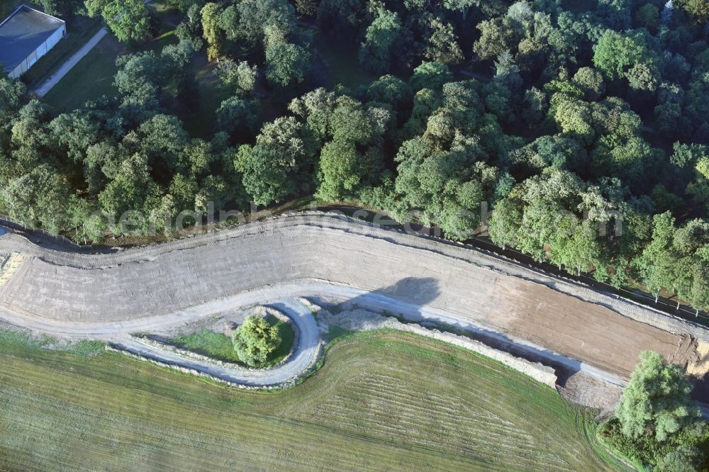 Pretzsch (Elbe) from the bird's eye view: Construction site of a new levee at the castle park and palace of Pretzsch (Elbe) in the state of Saxony-Anhalt. The levee is being put in place for protection against flooding and high tide of the river Elbe