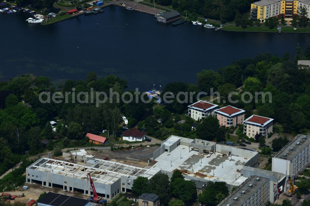 Erkner from above - Construction site for the new building of the shopping center City center on Friedrichstrasse - waterfront in Erkner in Brandenburg