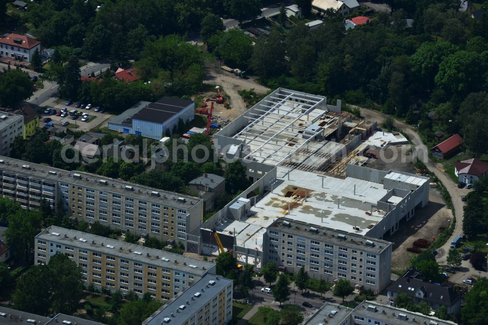 Erkner from the bird's eye view: Construction site for the new building of the shopping center City center on Friedrichstrasse - waterfront in Erkner in Brandenburg