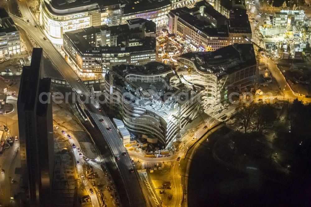 Aerial image Düsseldorf - Night shot of construction site for the construction of a new retail and office property Koe-arch in Dusseldorf in North Rhine-Westphalia. Between Königsallee boulevard and Hofgarten Schadowplatz, built the company Zechbau two 26-meter-high building complexes for retail and offices