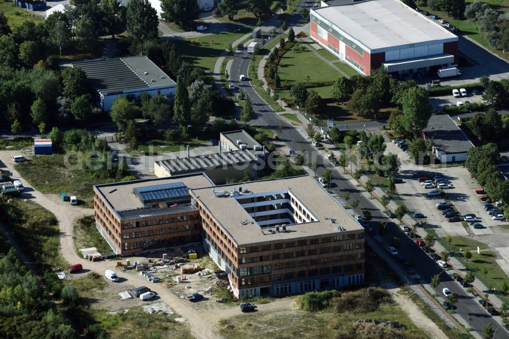 Aerial photograph Berlin - Construction site of the new company building of Flexim GmbH with a wooden facade on Boxberger Strasse in the district of Marzahn-Hellersdorf in Berlin