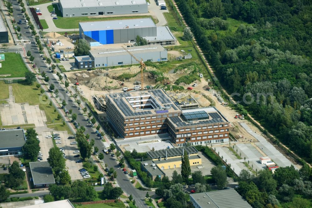 Aerial photograph Berlin - Construction site of the new company building of Flexim GmbH with a wooden facade on Boxberger Strasse in the district of Marzahn-Hellersdorf in Berlin