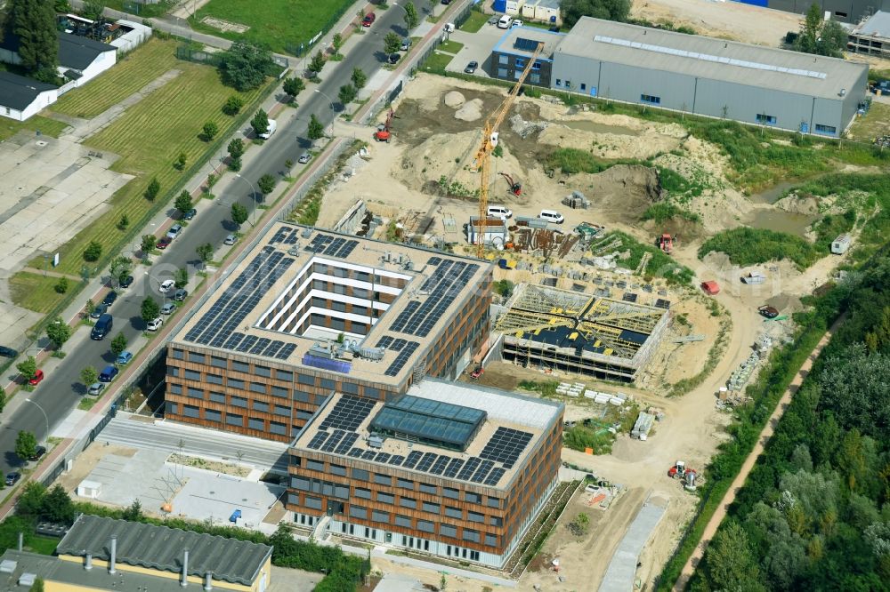 Aerial image Berlin - Construction site of the new company building of Flexim GmbH with a wooden facade on Boxberger Strasse in the district of Marzahn-Hellersdorf in Berlin