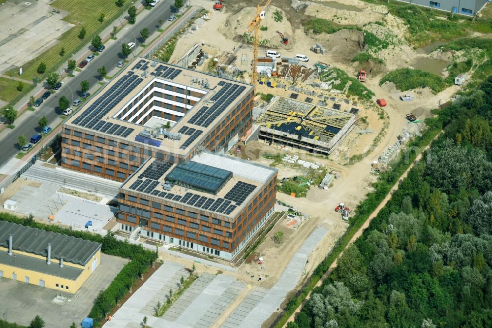 Aerial photograph Berlin - Construction site of the new company building of Flexim GmbH with a wooden facade on Boxberger Strasse in the district of Marzahn-Hellersdorf in Berlin