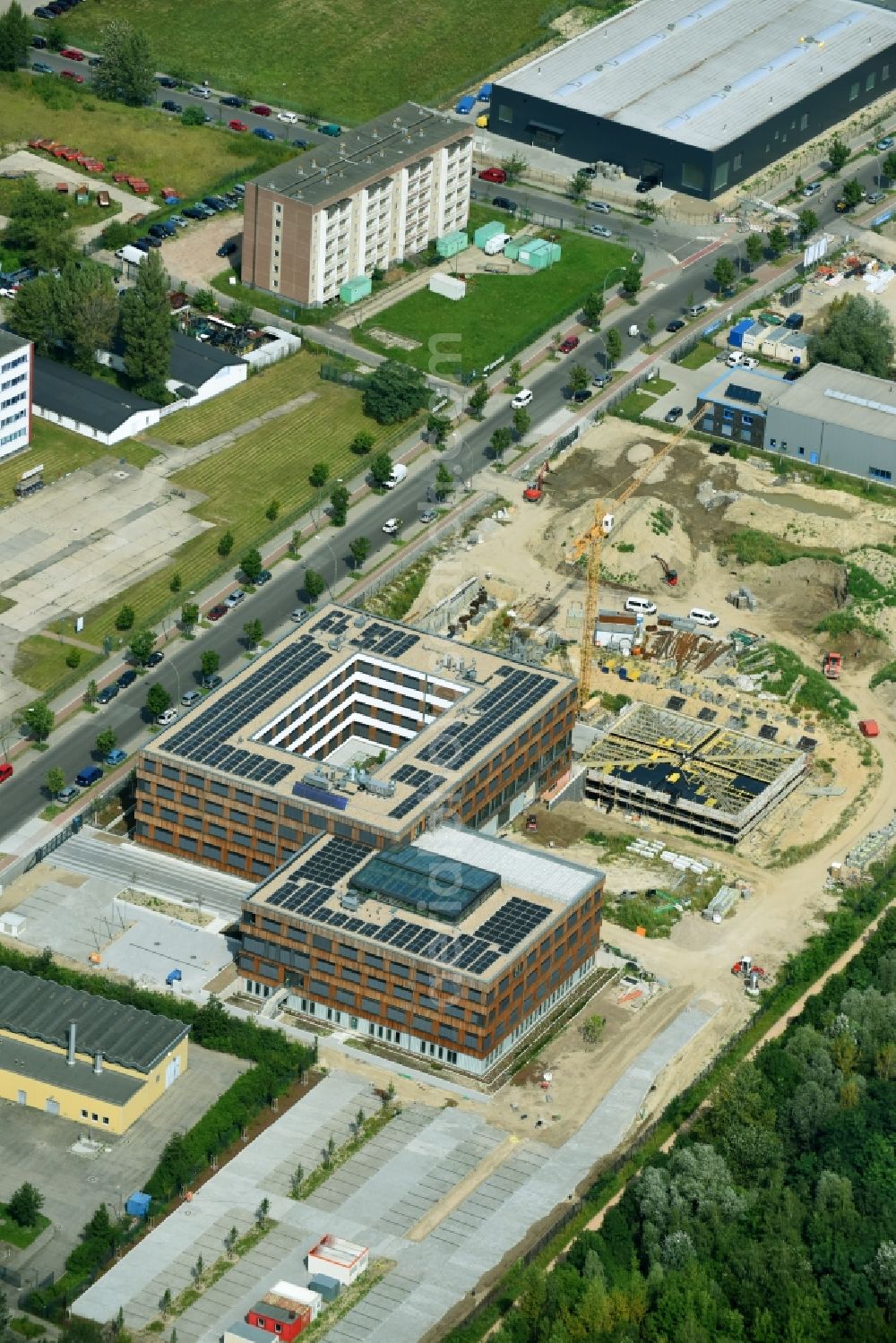 Berlin from above - Construction site of the new company building of Flexim GmbH with a wooden facade on Boxberger Strasse in the district of Marzahn-Hellersdorf in Berlin