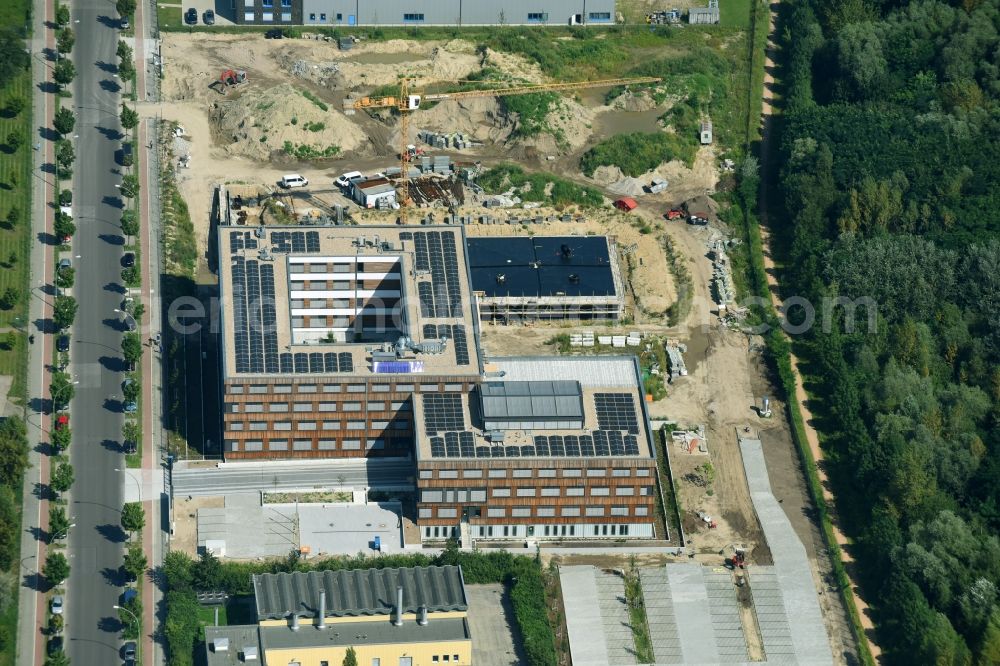 Berlin from above - Construction site of the new company building of Flexim GmbH with a wooden facade on Boxberger Strasse in the district of Marzahn-Hellersdorf in Berlin