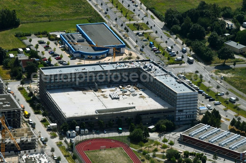 Schönefeld from the bird's eye view: New construction of the building complex of the shopping centeron Hans-Grade-Allee corner Rudower Chaussee in Schoenefeld in the state Brandenburg, Germany