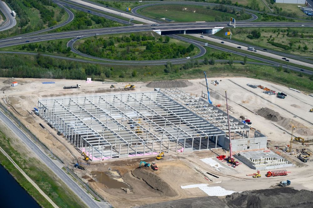 Wustermark from the bird's eye view: Construction site to build a new building complex on the site of the logistics center of Brueof Schlau GmbH & Co. KG in Wustermark in the state Brandenburg, Germany