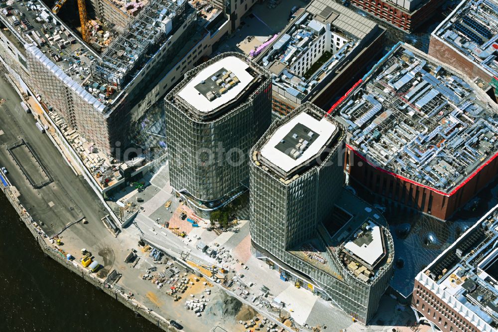 Hamburg from the bird's eye view: Construction site for new high-rise building complex UeBERSEEQUARTIER D1 UND D2 on street New-Orleans-Strasse in the district HafenCity in Hamburg, Germany