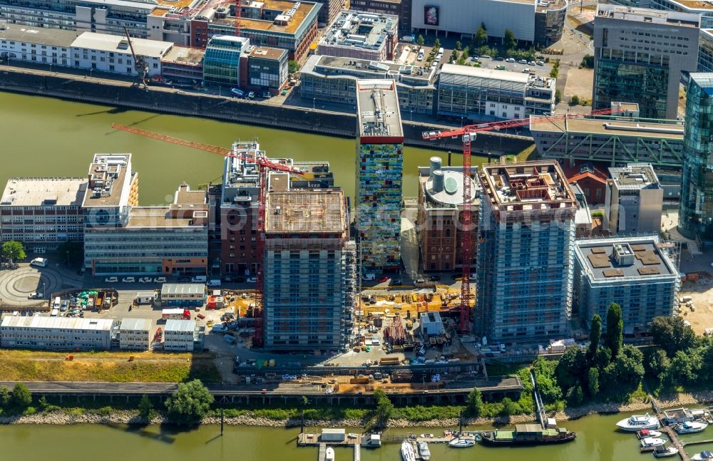 Düsseldorf from the bird's eye view: Construction site for new high-rise building complex Duesseldorfer Heimathafen in of Speditionstrasse in Duesseldorf in the state North Rhine-Westphalia, Germany