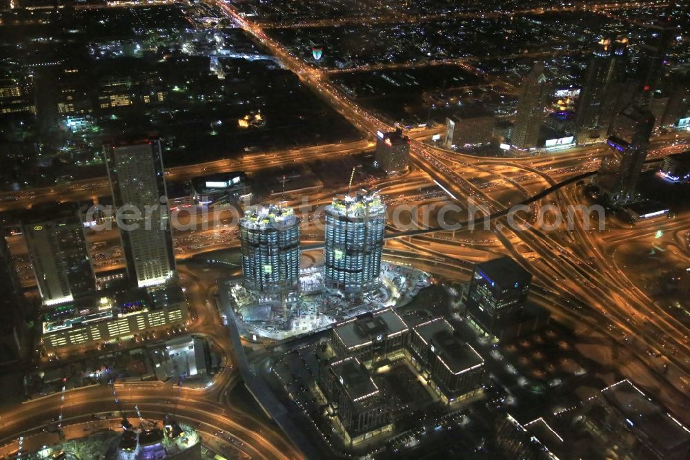 Dubai from above - Night view of Construction site for new high-rise building complex The Address Residence Sky View on Sheikh Zayed Rd in Dubai in United Arab Emirates