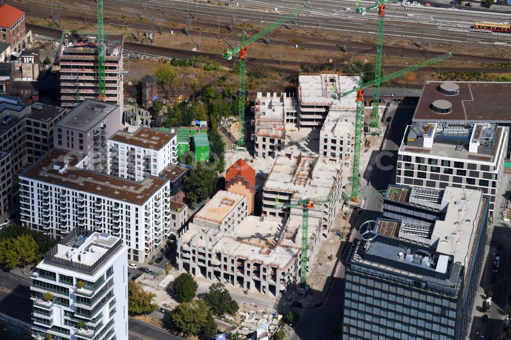 Berlin from the bird's eye view: Construction site for the new skyscraper ensemble Max und Moritz Quartier - UPSIDE BERLIN with residential and commercial units by the company DIE WOHNKOMPANIE Berlin GmbH and the architecture office Noefer Gesellschaft von Architekten mbH on Mariane-von-Rantzau-Strasse in the district Friedrichshain in Berlin, Germany