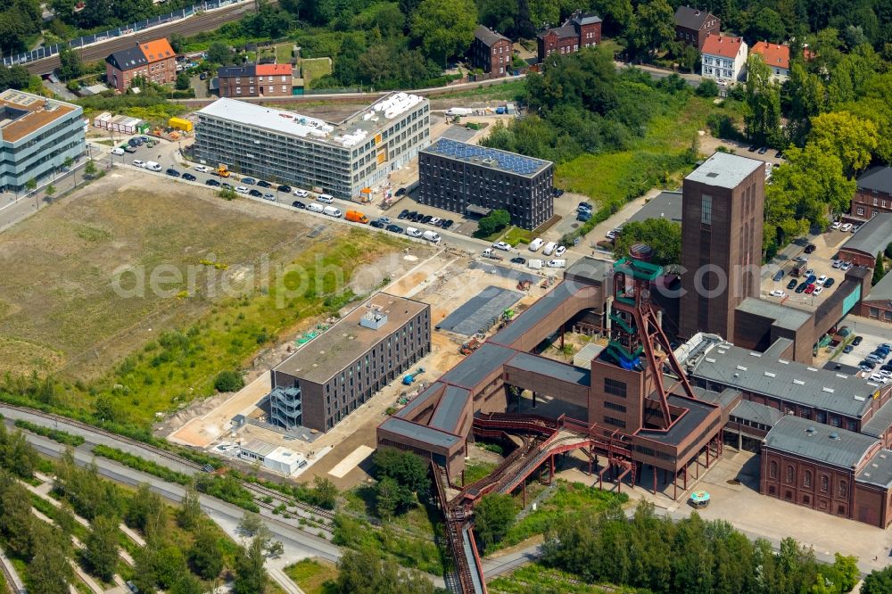 Essen from the bird's eye view: New construction site the hotel complex of the new opened hotel friends Zeche-Zollverein Essen overlooking the construction site of the office building at Martin-Kremmer-Strasse in Essen in the state North Rhine-Westphalia, Germany