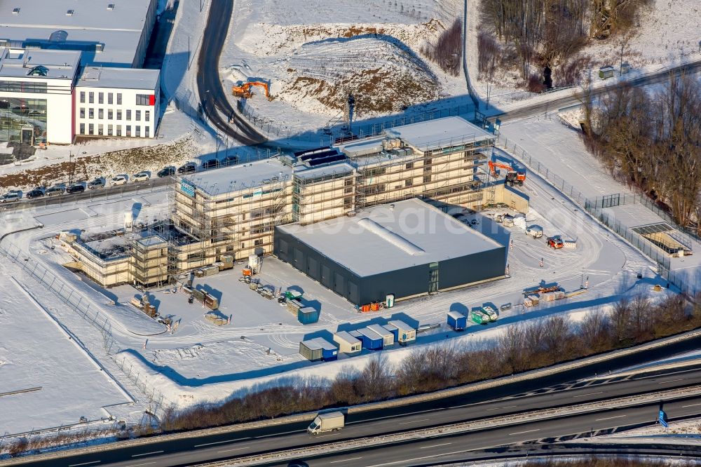 Meschede from the bird's eye view: Winterly snowy construction site for the new building of the fire station Kreisfeuerwehrzentrums HSK besides the motorway A 46 in Meschede in the state North Rhine-Westphalia