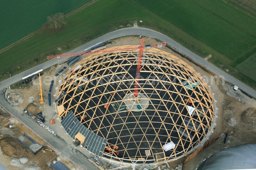 Aerial image Rheinfelden - Construction site for the new dome of the United Swiss Saltworks in Rheinfelden in Switzerland. The filigree wooden construction is the largest domed structure in Europe and serves as a salt deposit for de-icing salt for winter maintenance. The wooden grid shell dome is built from the wood technology company Haering 