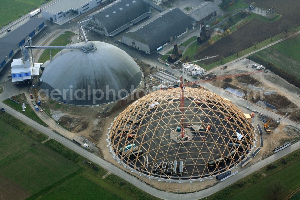 Rheinfelden from above - Construction site for the new dome of the United Swiss Saltworks in Rheinfelden in Switzerland. The filigree wooden construction is the largest domed structure in Europe and serves as a salt deposit for de-icing salt for winter maintenance. The wooden grid shell dome is built from the wood technology company Haering 