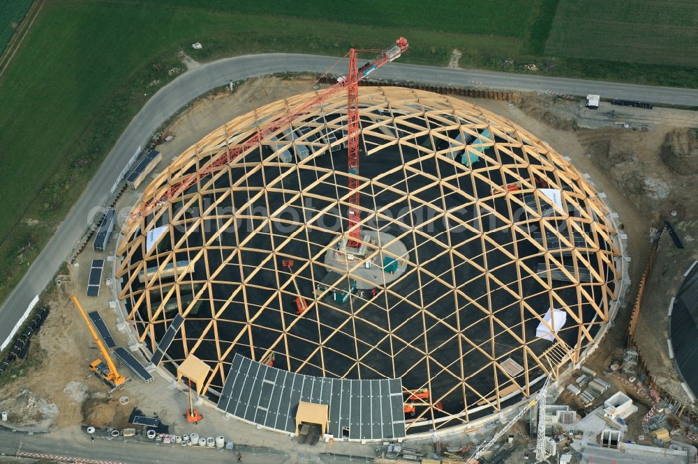 Rheinfelden from the bird's eye view: Construction site for the new dome of the United Swiss Saltworks in Rheinfelden in Switzerland. The filigree wooden construction is the largest domed structure in Europe and serves as a salt deposit for de-icing salt for winter maintenance. The wooden grid shell dome is built from the wood technology company Haering 