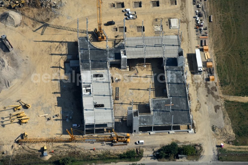 Berlin from the bird's eye view: Construction site for the new building home-center of the Porta-Group at Pilgramer street in the district Mahlsdorf in Berlin