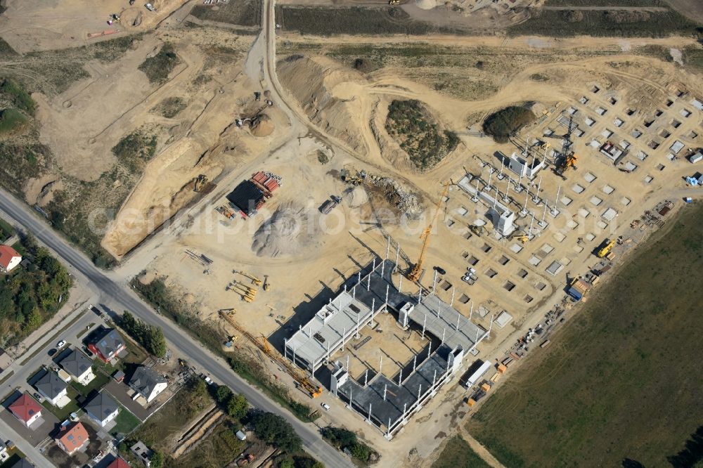 Berlin from the bird's eye view: Construction site for the new building home-center of the Porta-Group at Pilgramer street in the district Mahlsdorf in Berlin