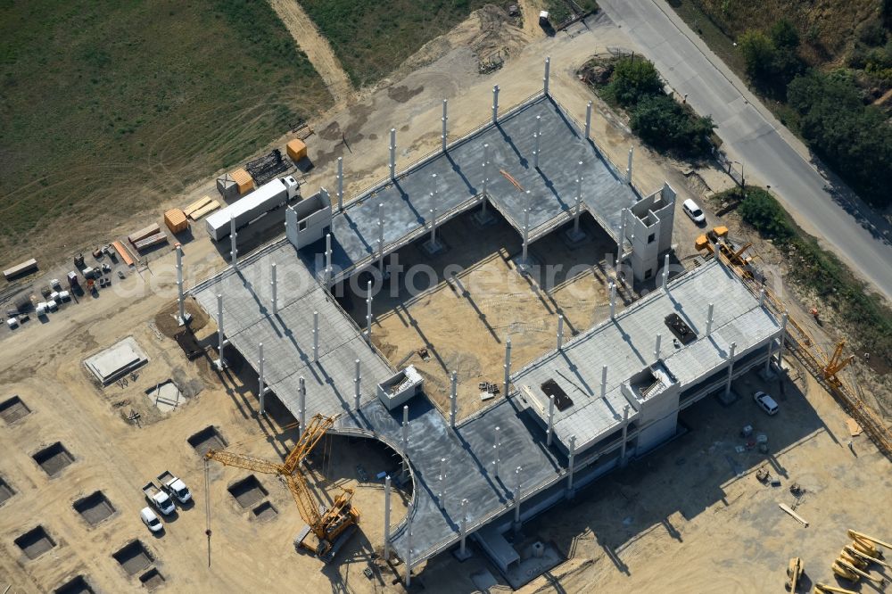 Berlin from the bird's eye view: Construction site for the new building home-center of the Porta-Group at Pilgramer street in the district Mahlsdorf in Berlin